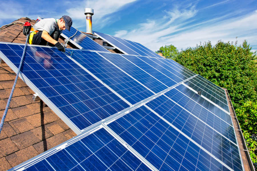 Solar Panel Installer on a Roof